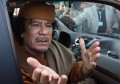 File photo of Libyan leader Muammar Gaddafi gesturing from a car in the compound of Bab Al Azizia in Tripoli