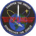 Top Hand patch from Vandenburg AFB showing a sword crossing orbital rings with the text Sharpen the Sword Strengthen the Shield