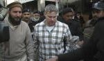 Raymond Davis escorted by Pakistani security officials to court in Lahore