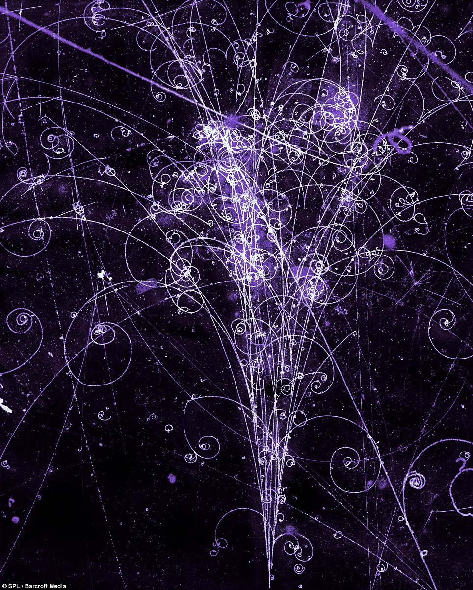 Detailed particle collision pattern showing colorful tracks radiating from a central impact point at CERN