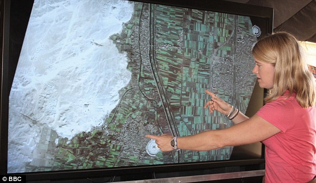 Dr. Sarah Parcak pointing to a buried pyramid location on satellite imagery
