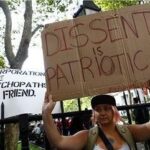 Occupy Wall Street protest signs advocating for economic justice