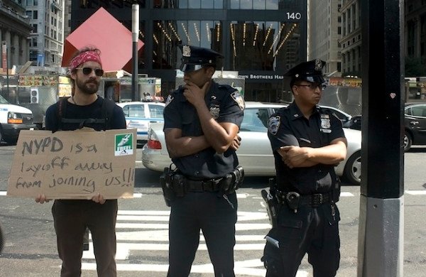 Large crowd of Occupy Wall Street demonstrators marching through New York streets