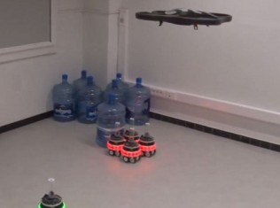 Watch A Swarm Of Robots Team Up With Flying Drones To Solve Real-World Problems