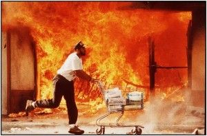 Looter during urban riot carrying stolen goods
